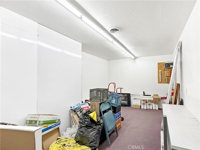 game room with dark colored carpet