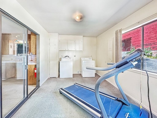 workout area with washer and dryer and a healthy amount of sunlight