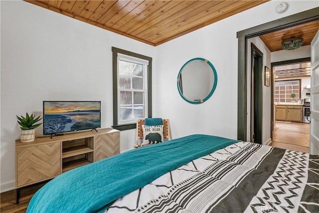 bedroom with wood ceiling, crown molding, and hardwood / wood-style flooring