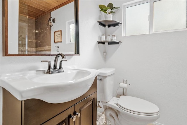 bathroom featuring vanity, toilet, and wooden ceiling