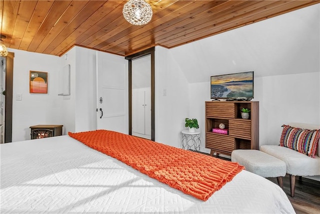 bedroom with wood ceiling and hardwood / wood-style floors