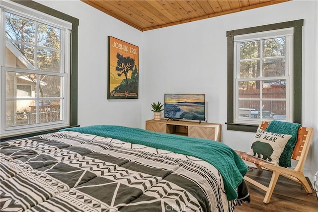 bedroom featuring multiple windows, crown molding, hardwood / wood-style floors, and wood ceiling