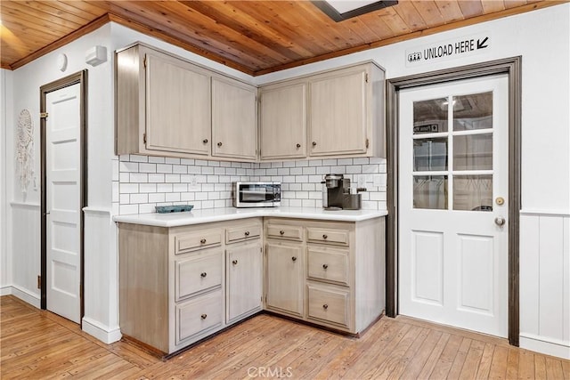 kitchen with crown molding, wooden ceiling, light wood-type flooring, and decorative backsplash