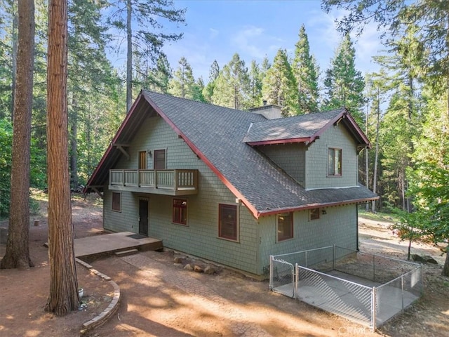 rear view of property with a balcony