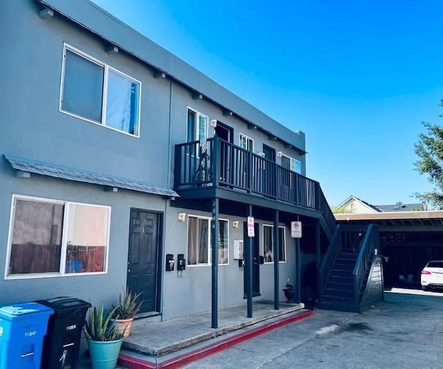 rear view of property featuring a balcony