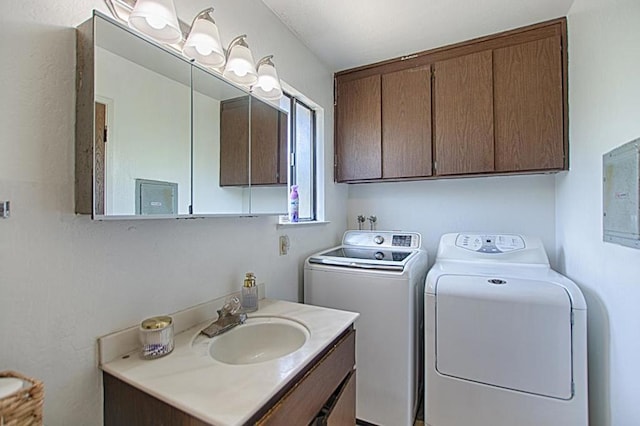 laundry area with washing machine and clothes dryer and sink