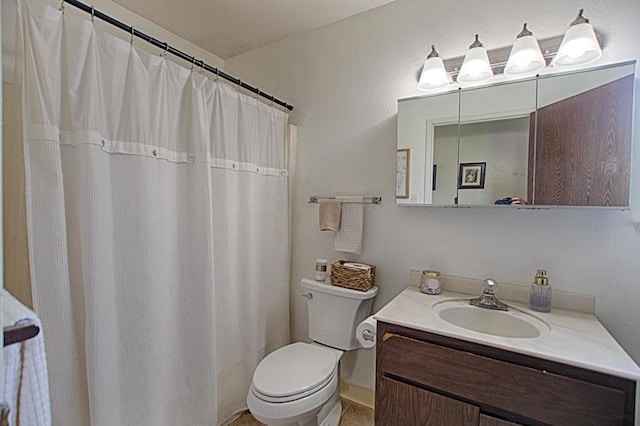 bathroom featuring large vanity and toilet