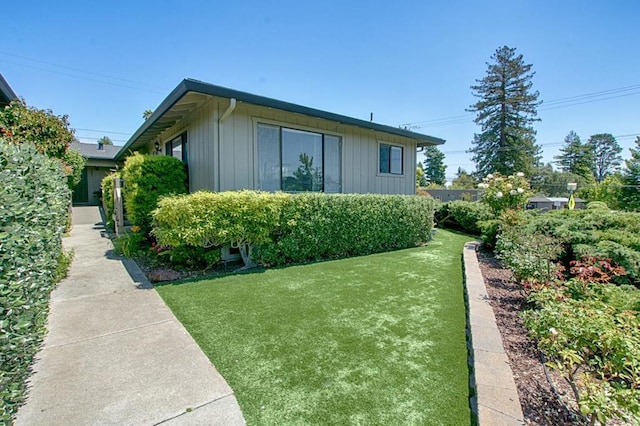 view of home's exterior with a lawn