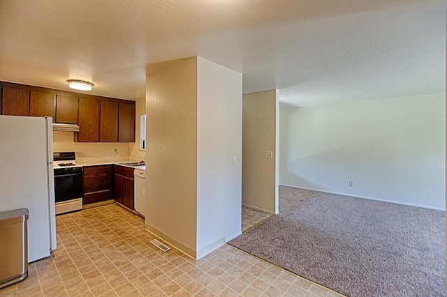 kitchen with white appliances, ventilation hood, dark brown cabinets, and light tile flooring