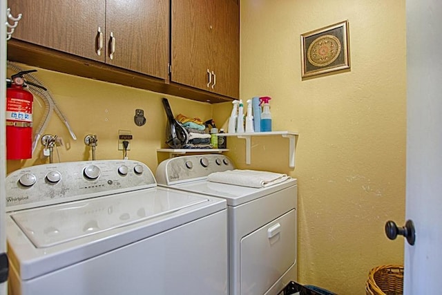 clothes washing area featuring cabinets and independent washer and dryer