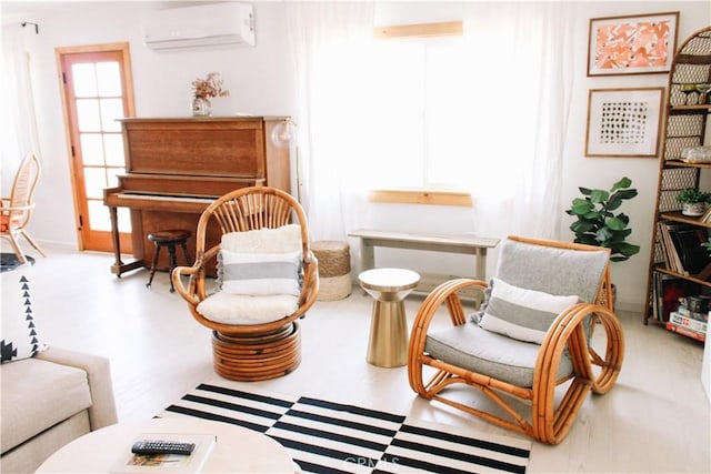 sitting room with a wall mounted air conditioner