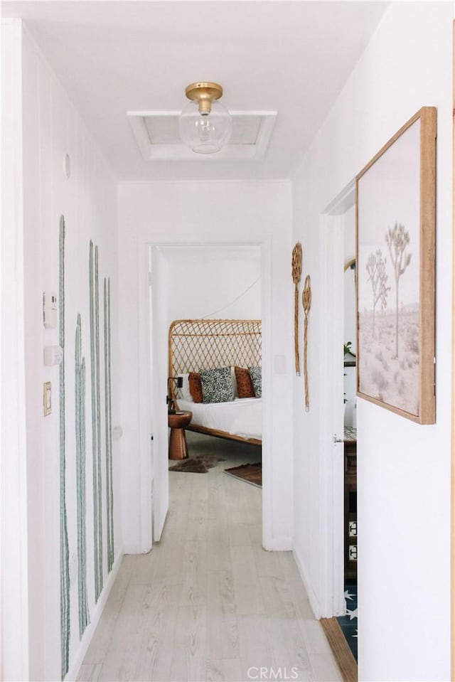 corridor with light hardwood / wood-style floors