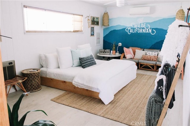 bedroom with ceiling fan, hardwood / wood-style floors, and a wall mounted air conditioner