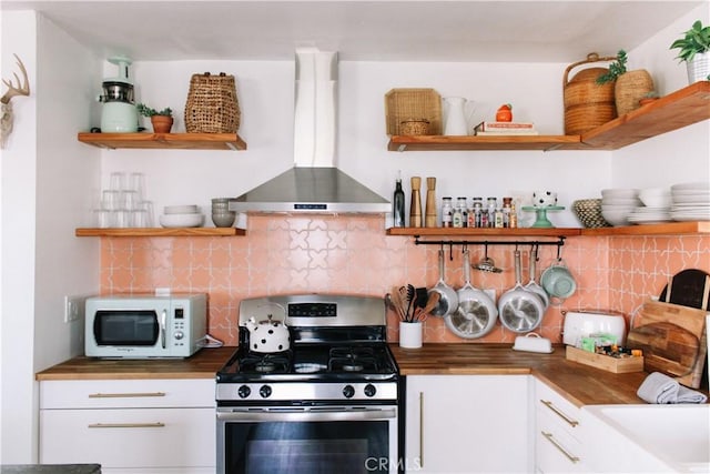 kitchen with white cabinets, stainless steel range with gas cooktop, backsplash, and exhaust hood