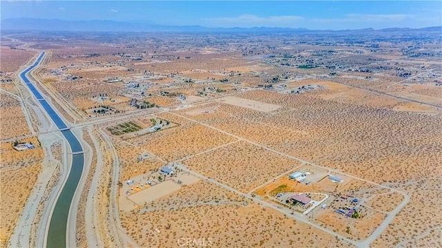 drone / aerial view with view of desert and a mountain view