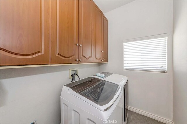 laundry room featuring light tile flooring, cabinets, independent washer and dryer, and hookup for a washing machine