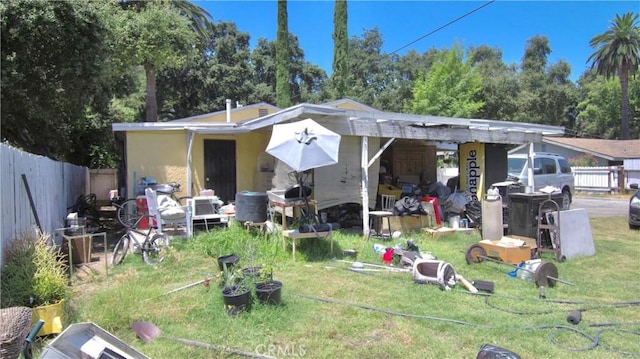 rear view of house with an outdoor structure