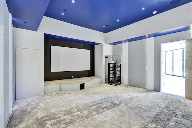 home theater room with light colored carpet