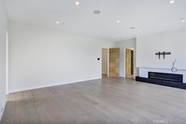 unfurnished living room featuring light hardwood / wood-style flooring