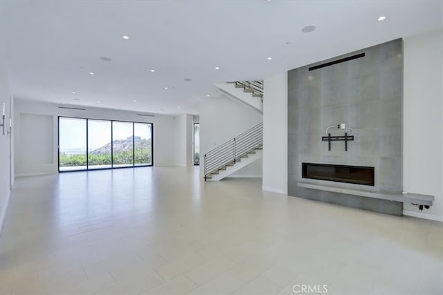 unfurnished living room with light tile floors and a fireplace