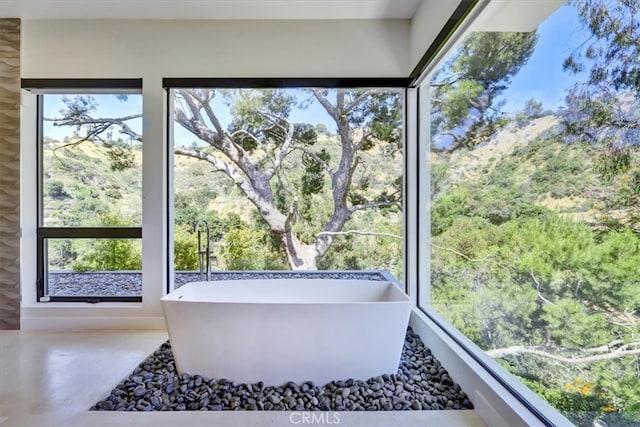 bathroom featuring concrete flooring and a wealth of natural light