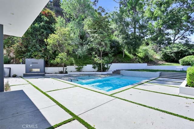 view of swimming pool with a patio area