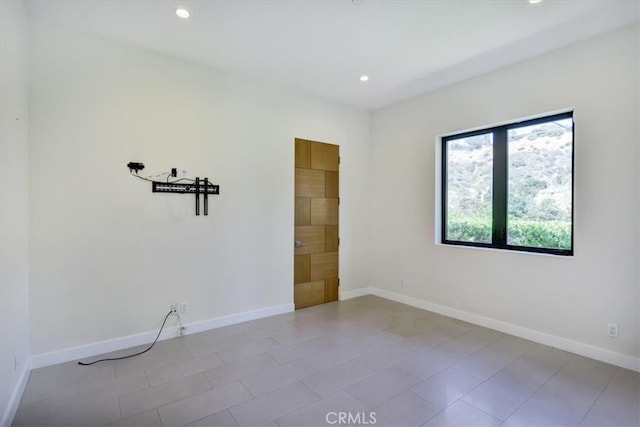 spare room featuring light tile floors