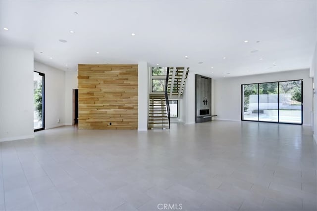 unfurnished living room featuring light tile flooring