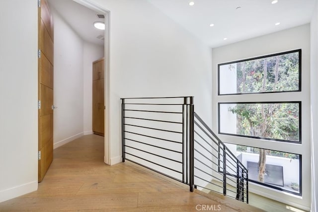 hallway with light hardwood / wood-style floors