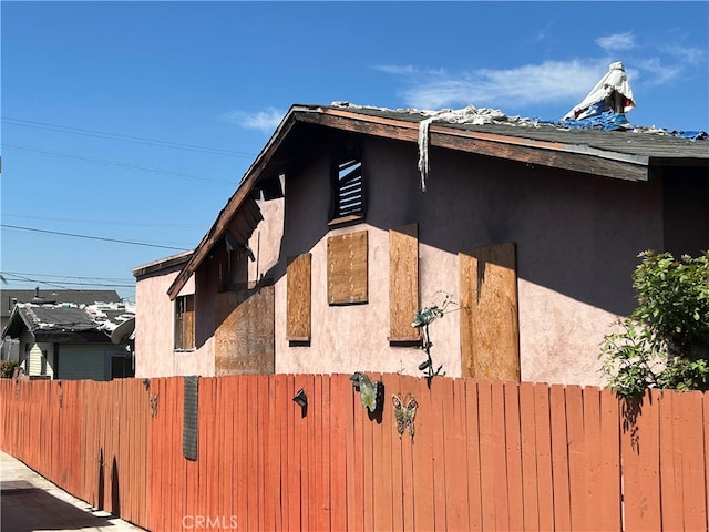 view of home's exterior featuring fence and stucco siding