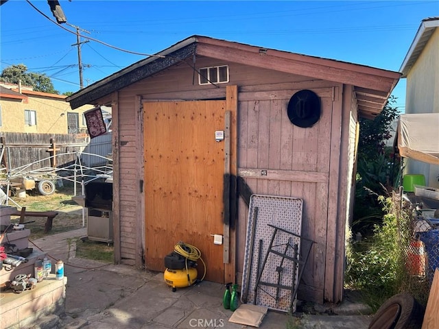 view of shed with fence