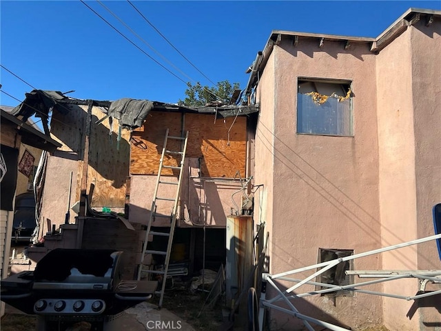 view of side of property with stucco siding