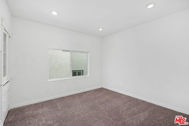 unfurnished room featuring carpet flooring