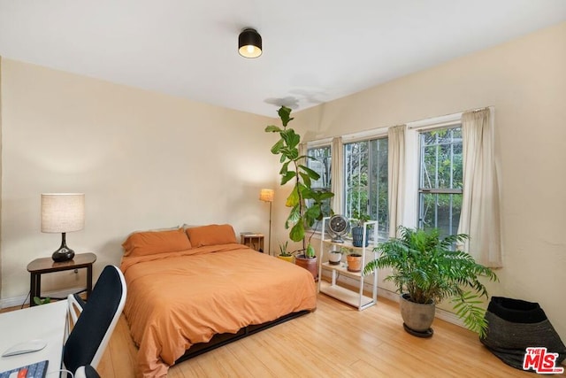 bedroom with wood-type flooring