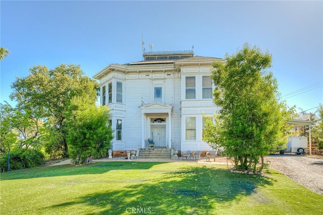 italianate-style house with a front yard