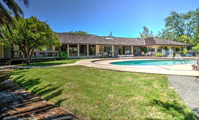 view of swimming pool with a patio area and a lawn