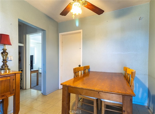 carpeted dining room with ceiling fan