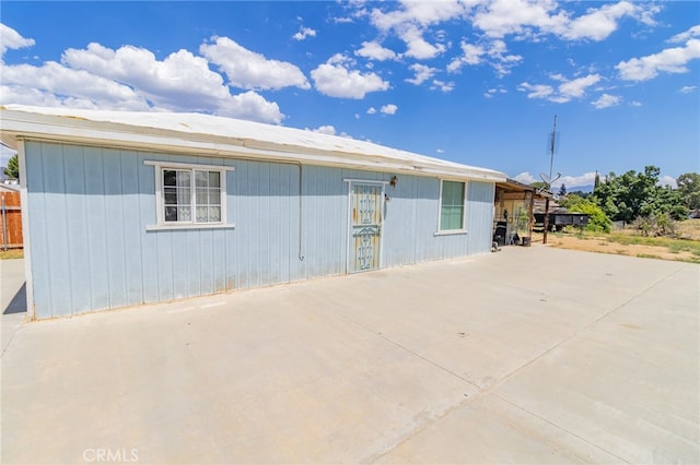 view of property exterior with a patio area