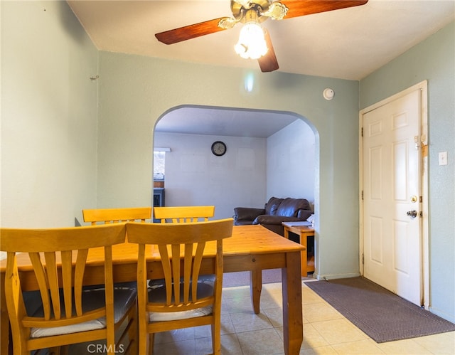 dining area featuring light tile floors and ceiling fan