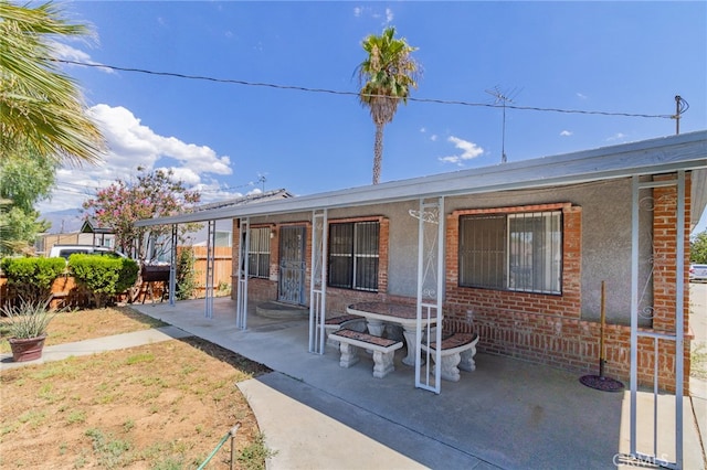 rear view of property featuring a patio