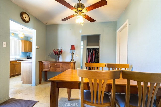 dining space featuring light tile floors and ceiling fan