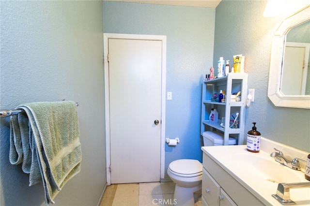 bathroom featuring tile flooring, toilet, and large vanity