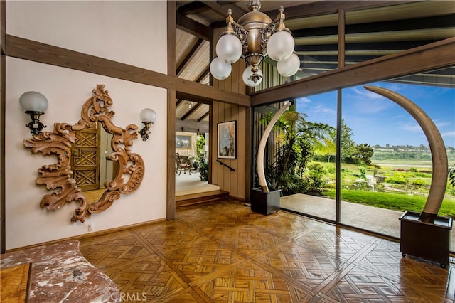 sunroom with a chandelier, beam ceiling, and a healthy amount of sunlight