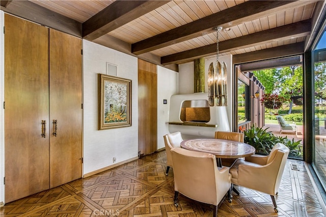 interior space featuring an inviting chandelier, wooden ceiling, dark parquet flooring, and beamed ceiling