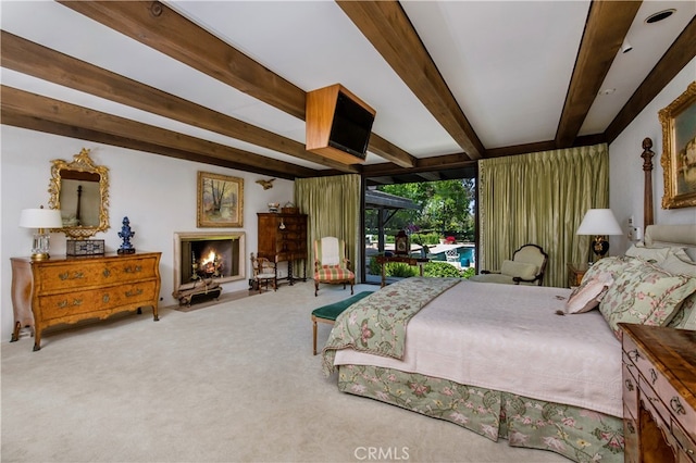 bedroom featuring carpet floors and beam ceiling