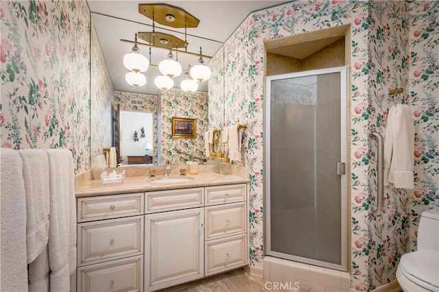 bathroom with toilet, walk in shower, and vanity