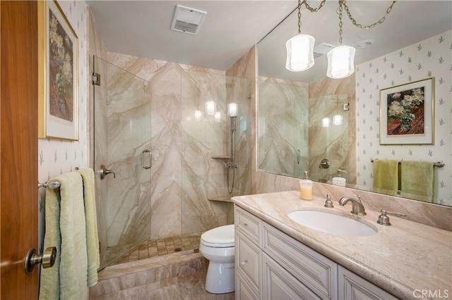 bathroom with vanity, tile walls, tile floors, a shower with door, and toilet