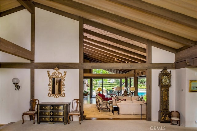 interior space with beam ceiling, a chandelier, and light carpet