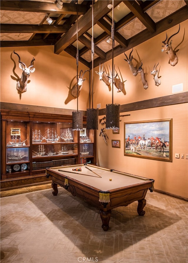 recreation room featuring pool table, a towering ceiling, and beamed ceiling