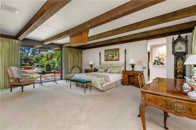 carpeted bedroom with beam ceiling